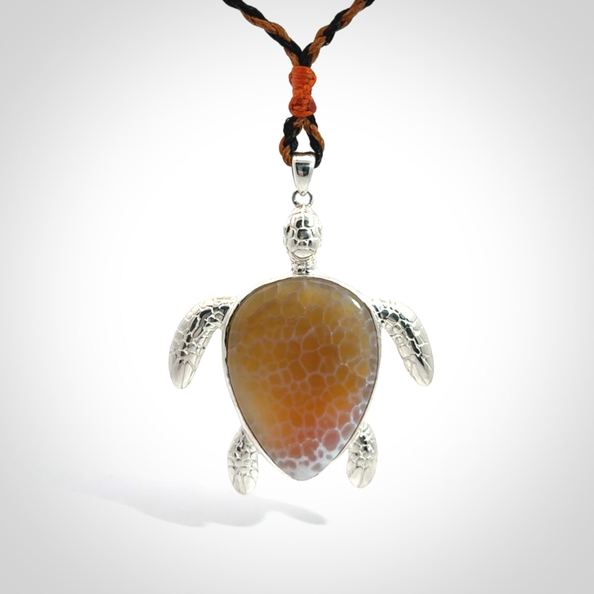 Snakeskin Agate stone turtle in Sterling silver engraved casing. Hand carved jewellery made by NZ Pacific and for sale online.