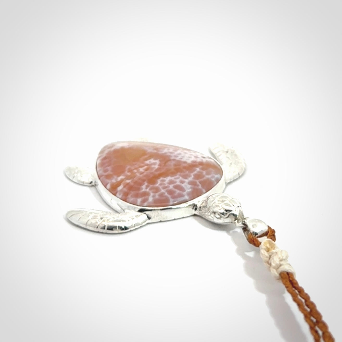 Snakeskin Agate stone turtle in Sterling silver engraved casing. Hand carved jewellery made by NZ Pacific and for sale online.