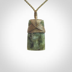 Hand carved from a lovely piece of local New Zealand Jade. We have suspended this from a 3-plait khaki cord which can be adjusted with a couple of slip knots and olive green binding.