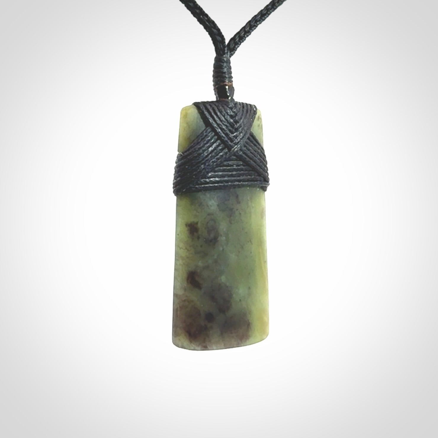 Hand carved from a lovely piece of local New Zealand Jade. We have suspended this from a black cord which can be adjusted with a couple of slip knots and black binding.