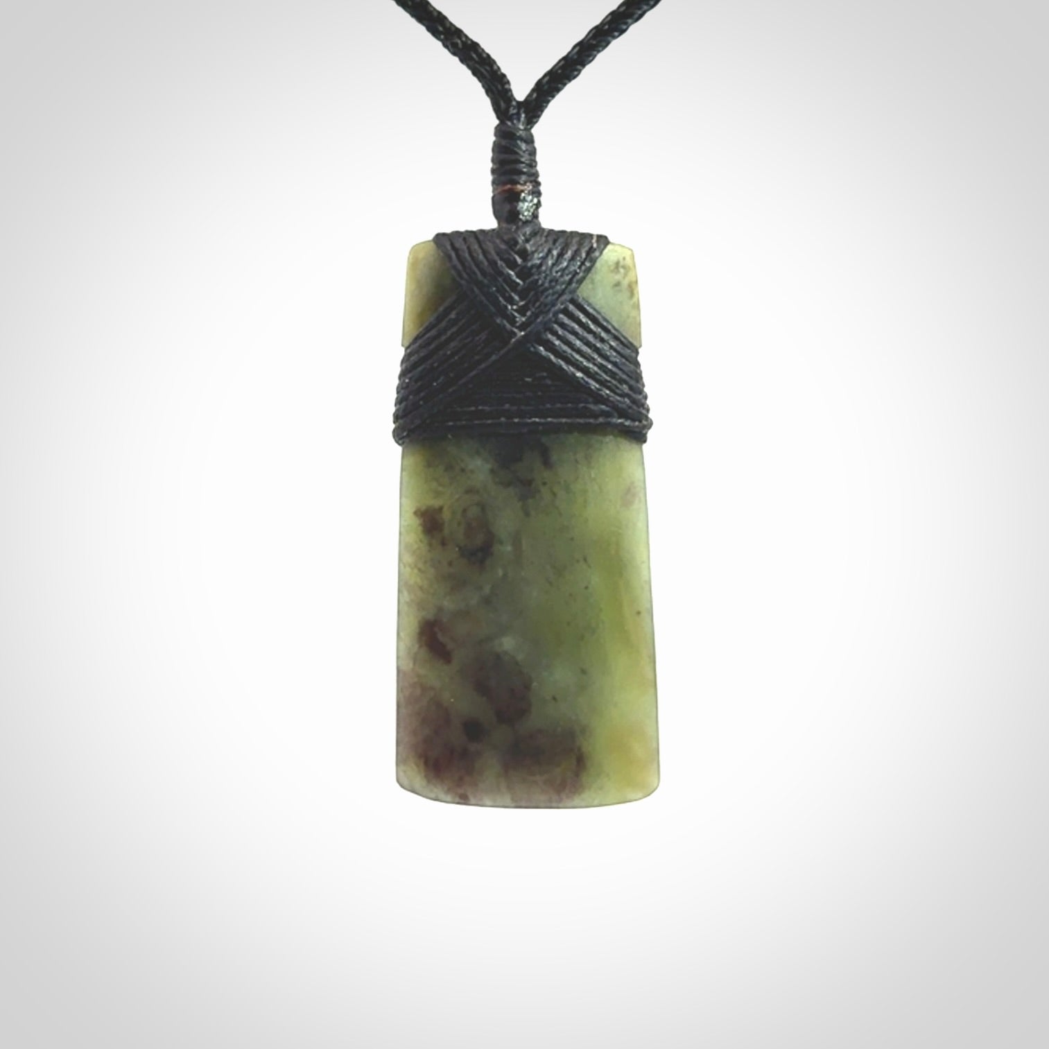 Hand carved from a lovely piece of local New Zealand Jade. We have suspended this from a black cord which can be adjusted with a couple of slip knots and black binding.