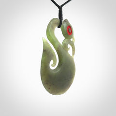 This picture shows a traditional manaia with hook pendant carved in New Zealand Jade.