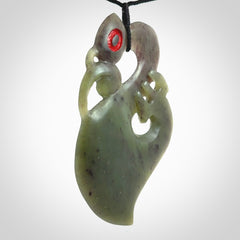 This picture shows a large traditional manaia pendant carved in New Zealand Jade.