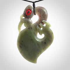 This picture shows a large traditional manaia pendant carved in New Zealand Jade.