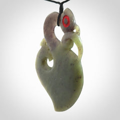 This picture shows a large traditional manaia pendant carved in New Zealand Jade.