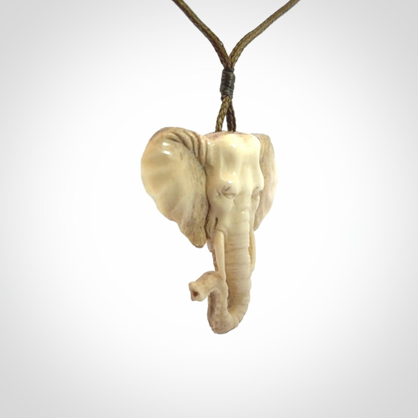 These are hand made elephant pendants, carved in a Deer Antler. The cord is length adjustable. Provided in a woven kete pouch and delivered with express courier.