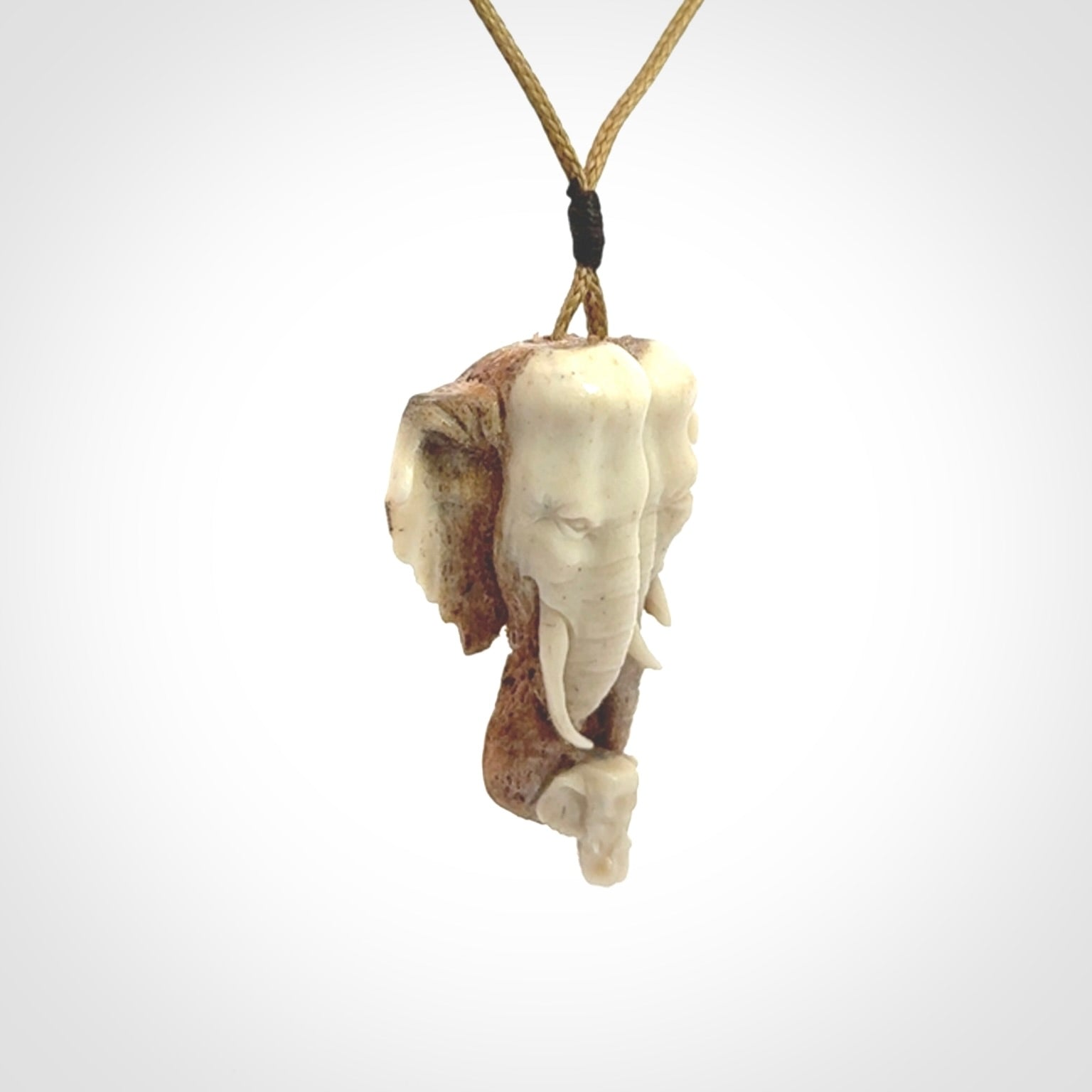 This is a triple elephant pendant, carved in a Deer Antler. The cord is length adjustable. Provided in a woven kete pouch and delivered with express courier.
