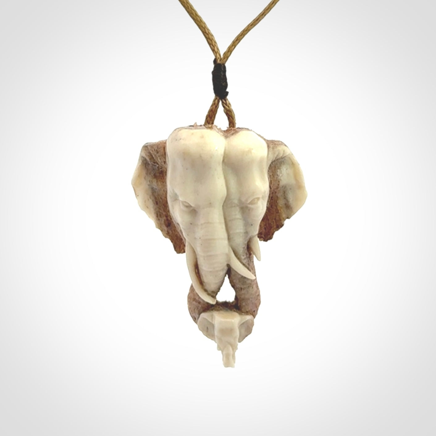 This is a triple elephant pendant, carved in a Deer Antler. The cord is length adjustable. Provided in a woven kete pouch and delivered with express courier.