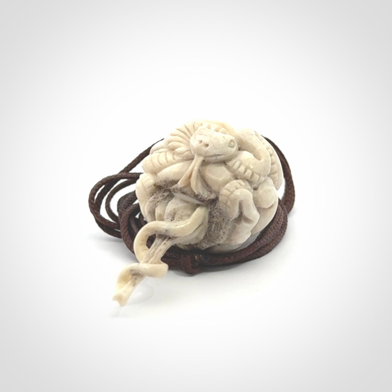 Hand carved deer antler brain with snake pendant. Hand carved by NZ Pacific. Free postage worldwide. Hand made brain with snake head necklace from deer antler. Brain with snake necklace for men and women.