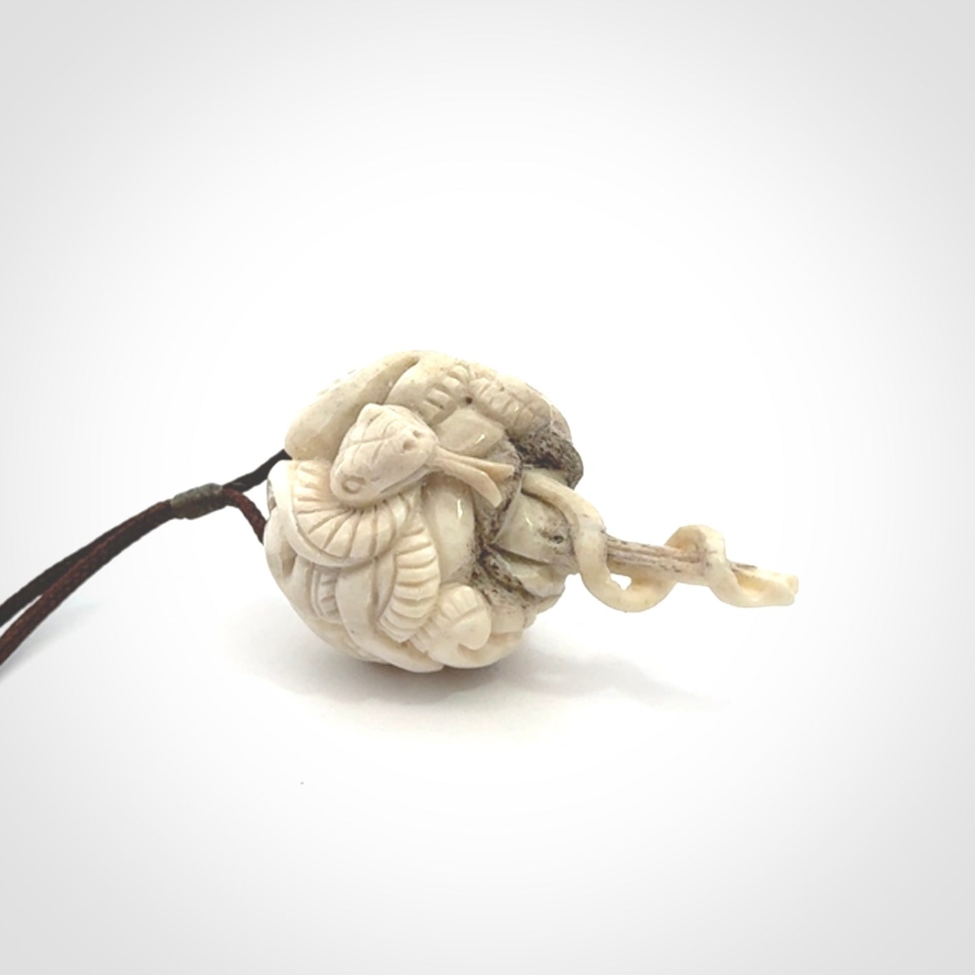 Hand carved deer antler brain with snake pendant. Hand carved by NZ Pacific. Free postage worldwide. Hand made brain with snake head necklace from deer antler. Brain with snake necklace for men and women.