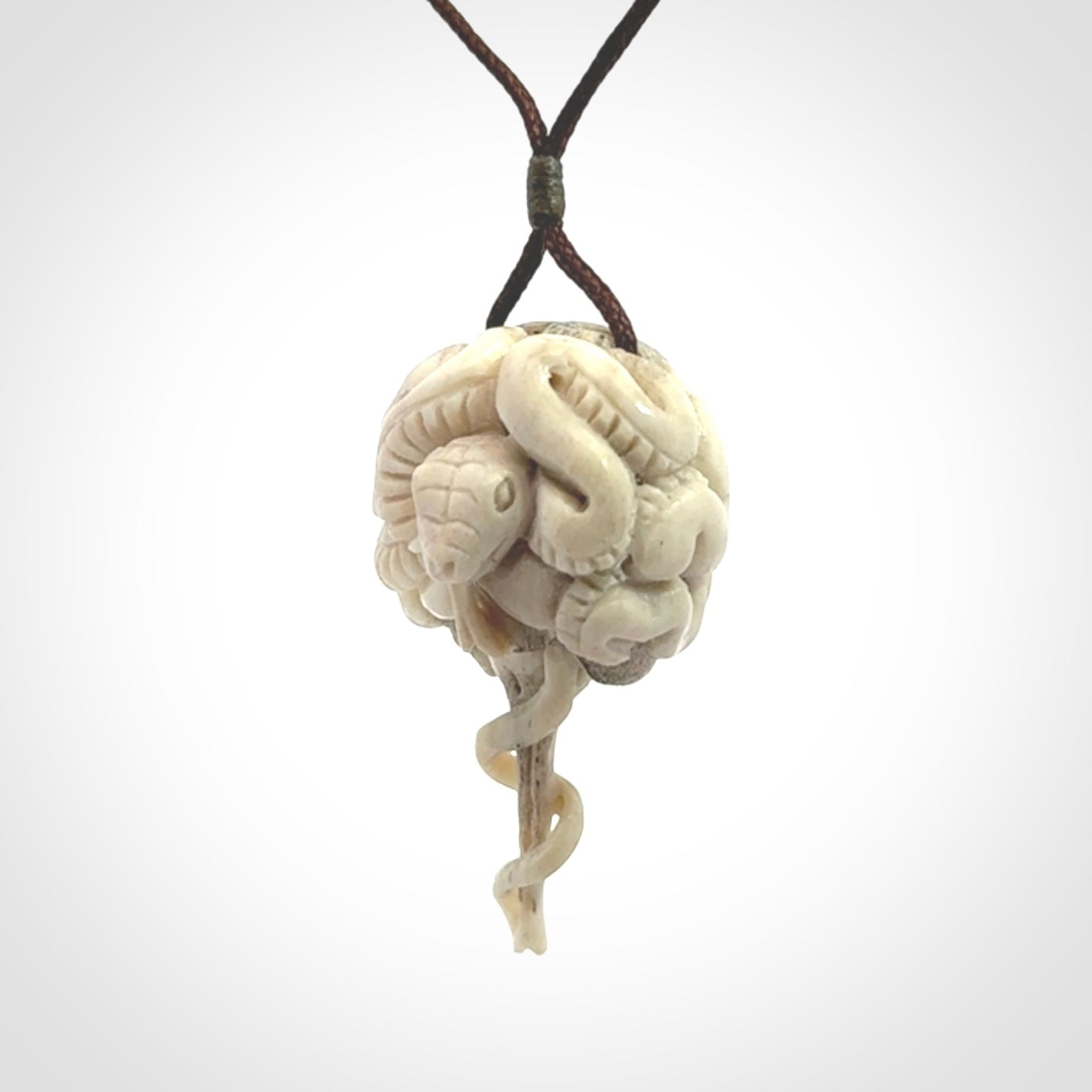 Hand carved deer antler brain with snake pendant. Hand carved by NZ Pacific. Free postage worldwide. Hand made brain with snake head necklace from deer antler. Brain with snake necklace for men and women.