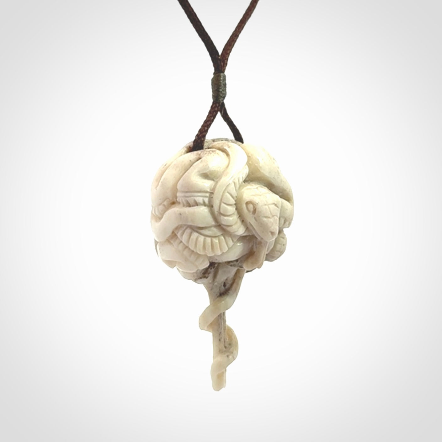 Hand carved deer antler brain with snake pendant. Hand carved by NZ Pacific. Free postage worldwide. Hand made brain with snake head necklace from deer antler. Brain with snake necklace for men and women.