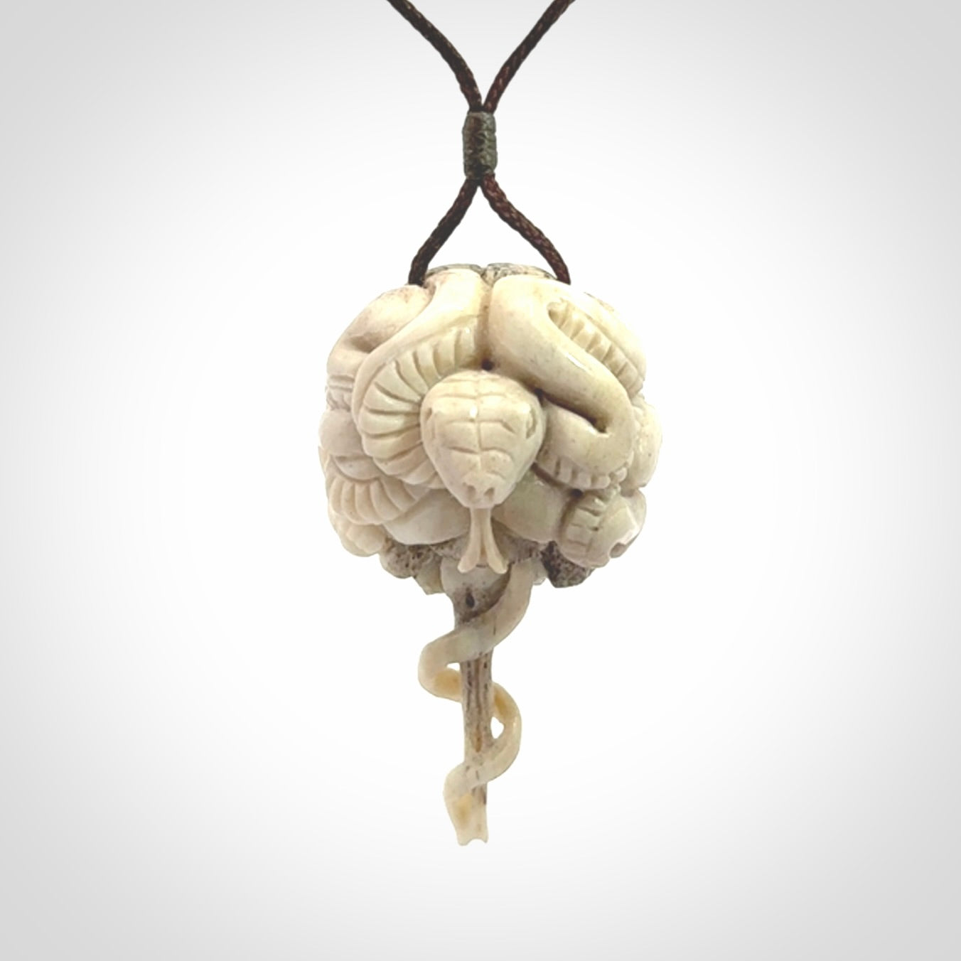 Hand carved deer antler brain with snake pendant. Hand carved by NZ Pacific. Free postage worldwide. Hand made brain with snake head necklace from deer antler. Brain with snake necklace for men and women.