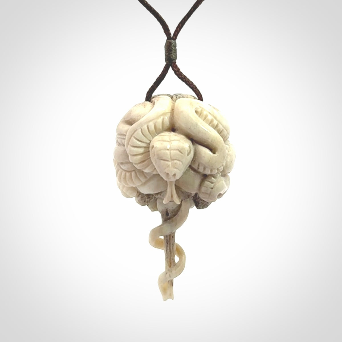 Hand carved deer antler brain with snake pendant. Hand carved by NZ Pacific. Free postage worldwide. Hand made brain with snake head necklace from deer antler. Brain with snake necklace for men and women.