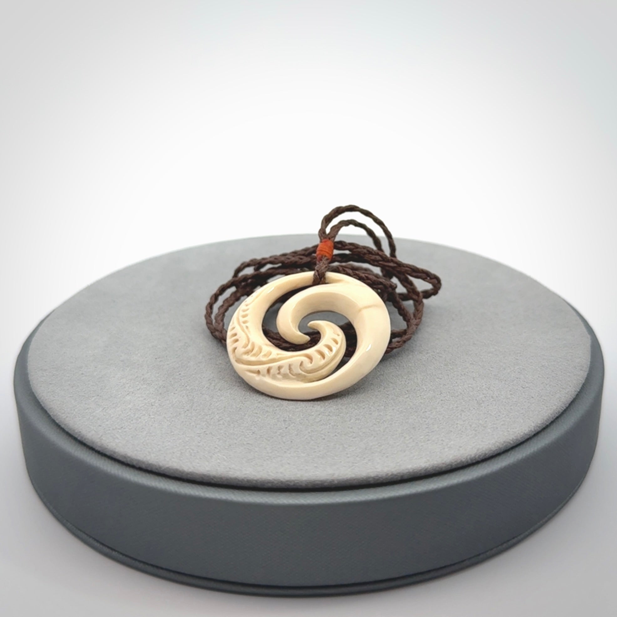 Hand carved koru pendant hand made in Woolly Mammoth tusk.