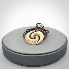 Hand carved koru pendant hand made in Woolly Mammoth tusk.