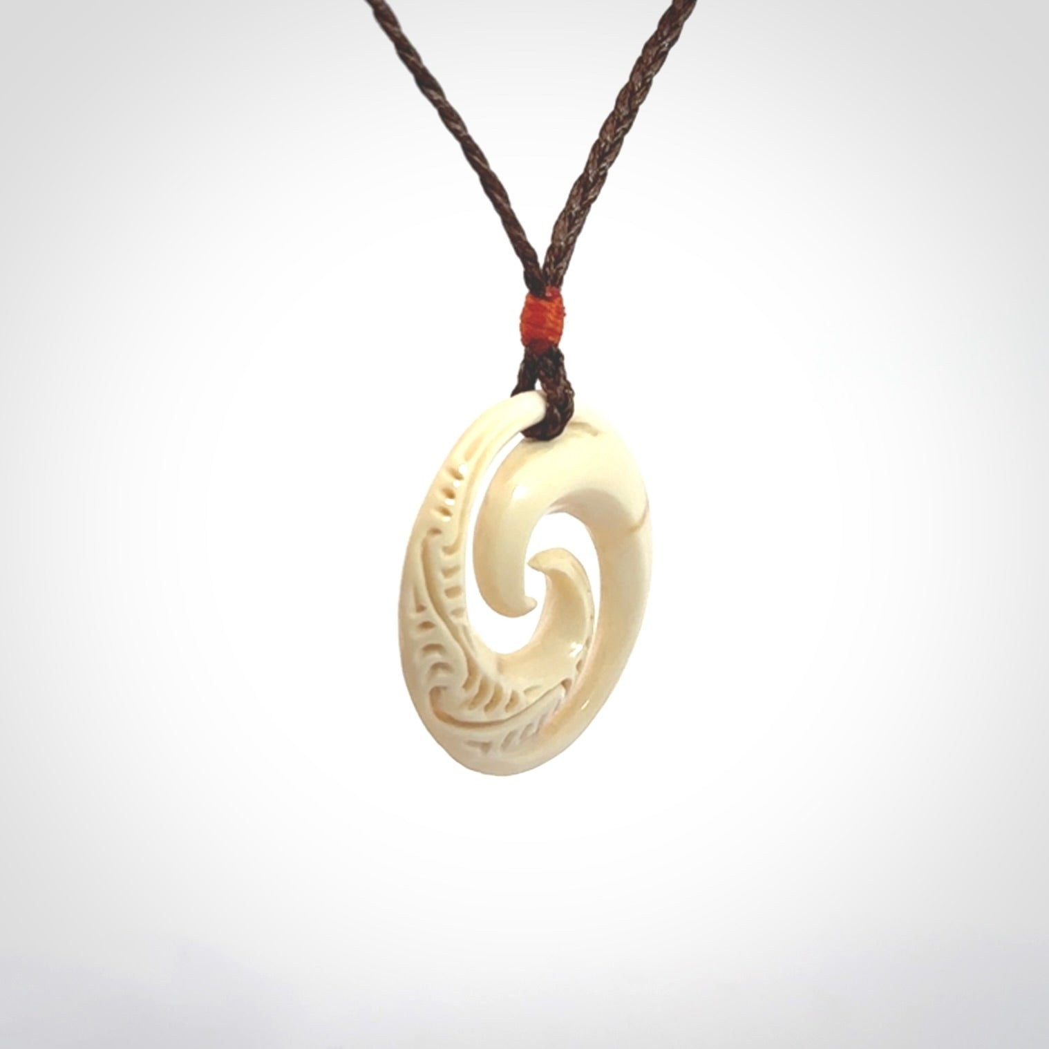 Hand carved koru pendant hand made in Woolly Mammoth tusk.