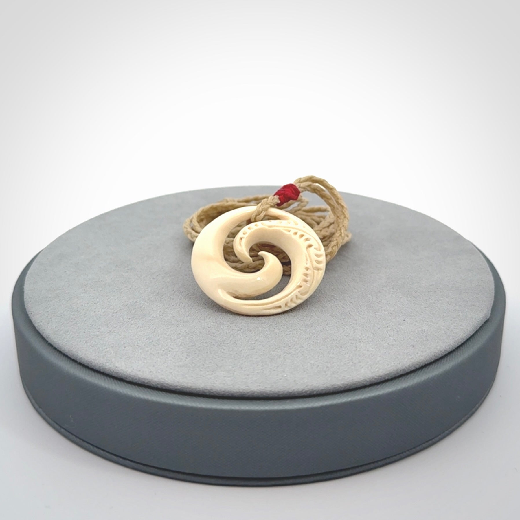 Hand carved koru pendant hand made in Woolly Mammoth tusk.