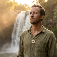 Man wearing a mammoth tusk koru pendant
