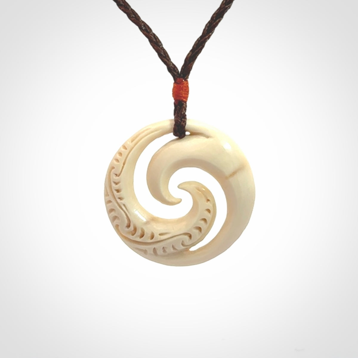 Hand carved koru pendant hand made in Woolly Mammoth tusk.