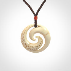 Hand carved koru pendant hand made in Woolly Mammoth tusk.