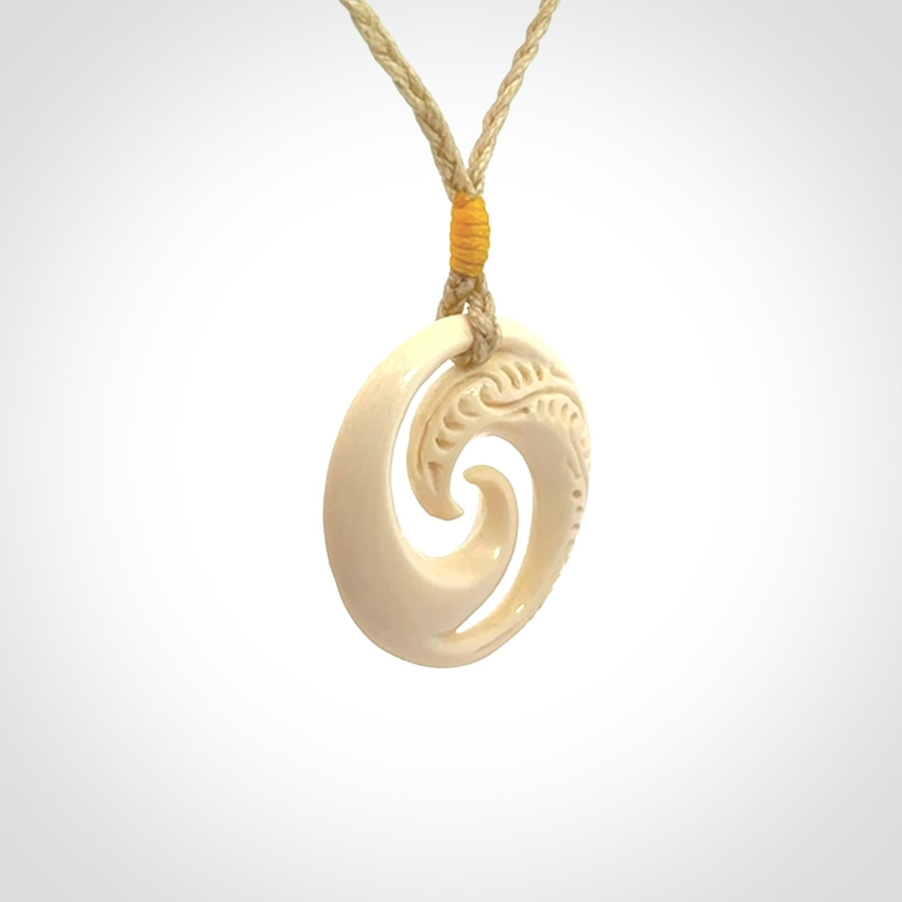 Hand carved koru pendant hand made in Woolly Mammoth tusk.
