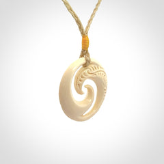 Hand carved koru pendant hand made in Woolly Mammoth tusk.