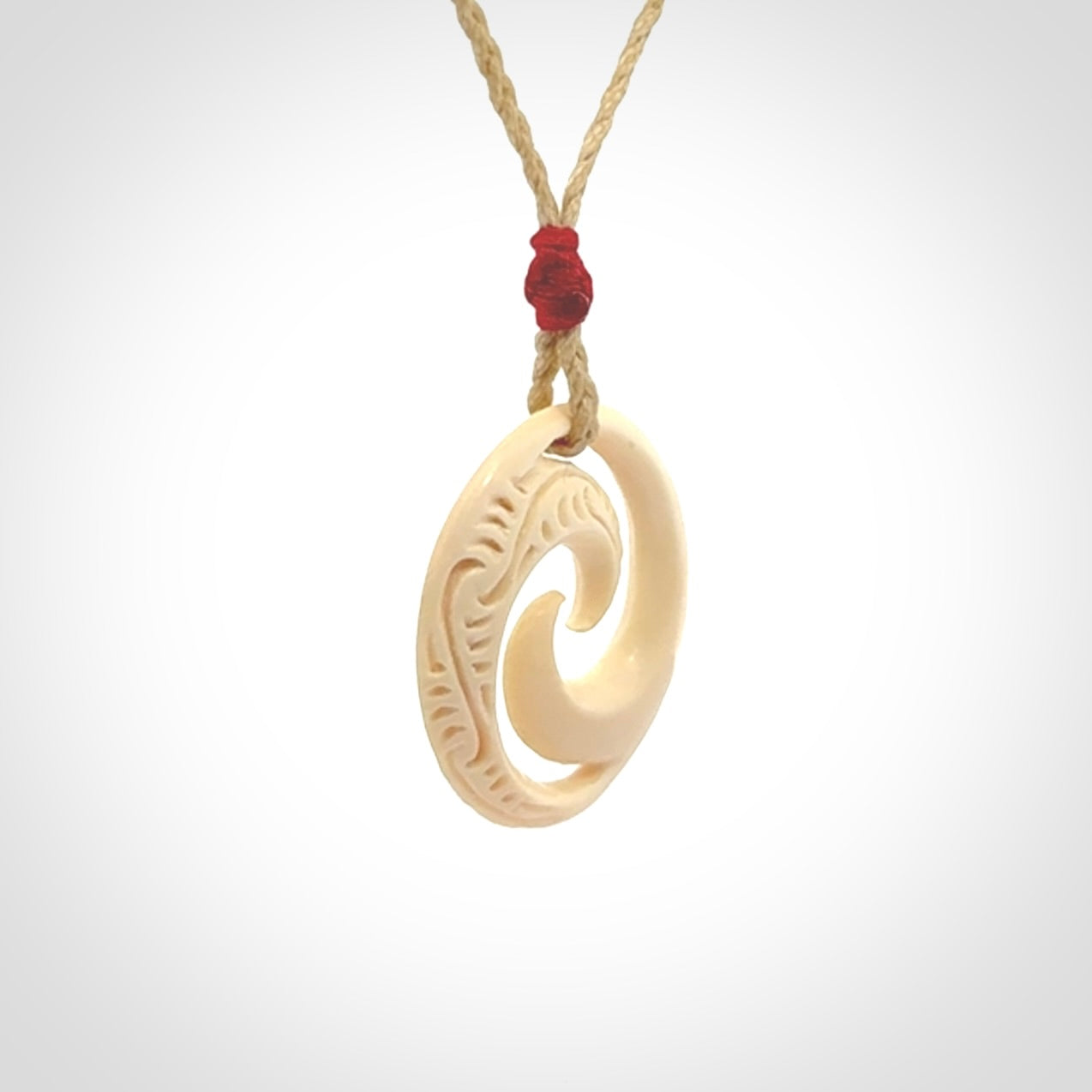 Hand carved koru pendant hand made in Woolly Mammoth tusk.