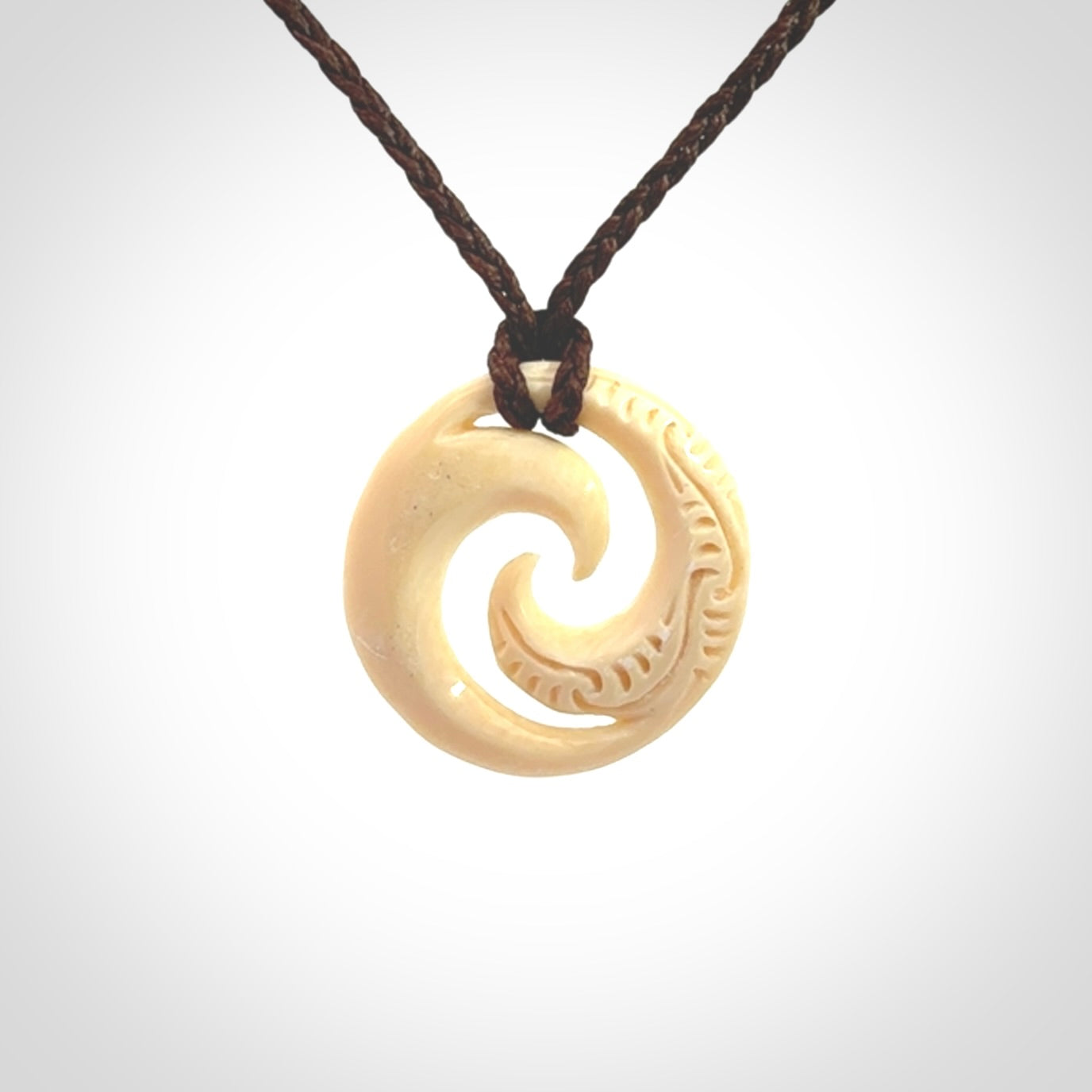 Hand carved koru pendant hand made in Woolly Mammoth tusk.