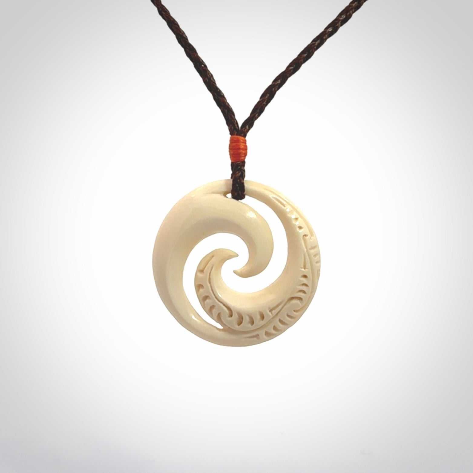 Hand carved koru pendant hand made in Woolly Mammoth tusk.