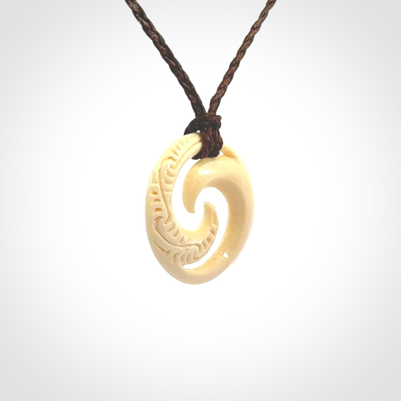 Hand carved koru pendant hand made in Woolly Mammoth tusk.