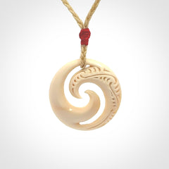 Hand carved koru pendant hand made in Woolly Mammoth tusk.
