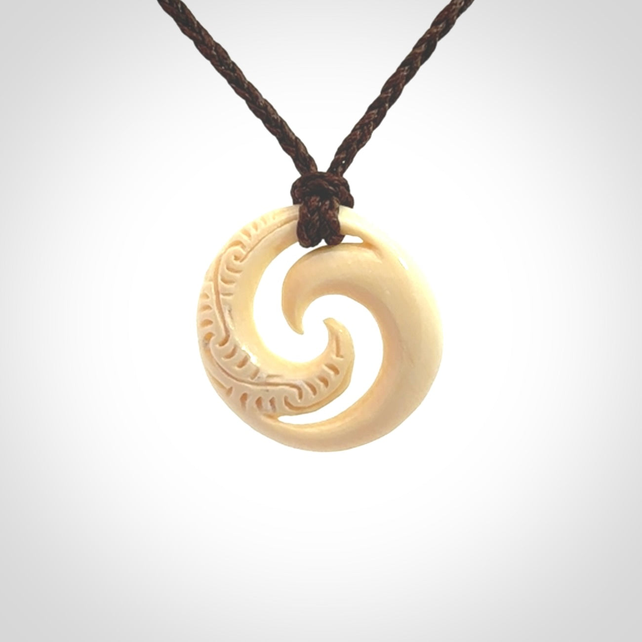 Hand carved koru pendant hand made in Woolly Mammoth tusk.