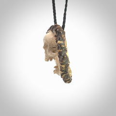 A hand carved SKULL pendant made from a piece of deer antler crown. This is a work of art carved in deer antler, bone. We deliver this pendant to you on a plaited black cord. Delivery with Express Courier is included in the price.