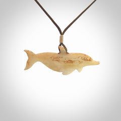 Hand carved dolphin bone pendant. Hand made bone dolphin necklace. Hand crafted bone dolphin pendant. Provided with an adjustable cord.