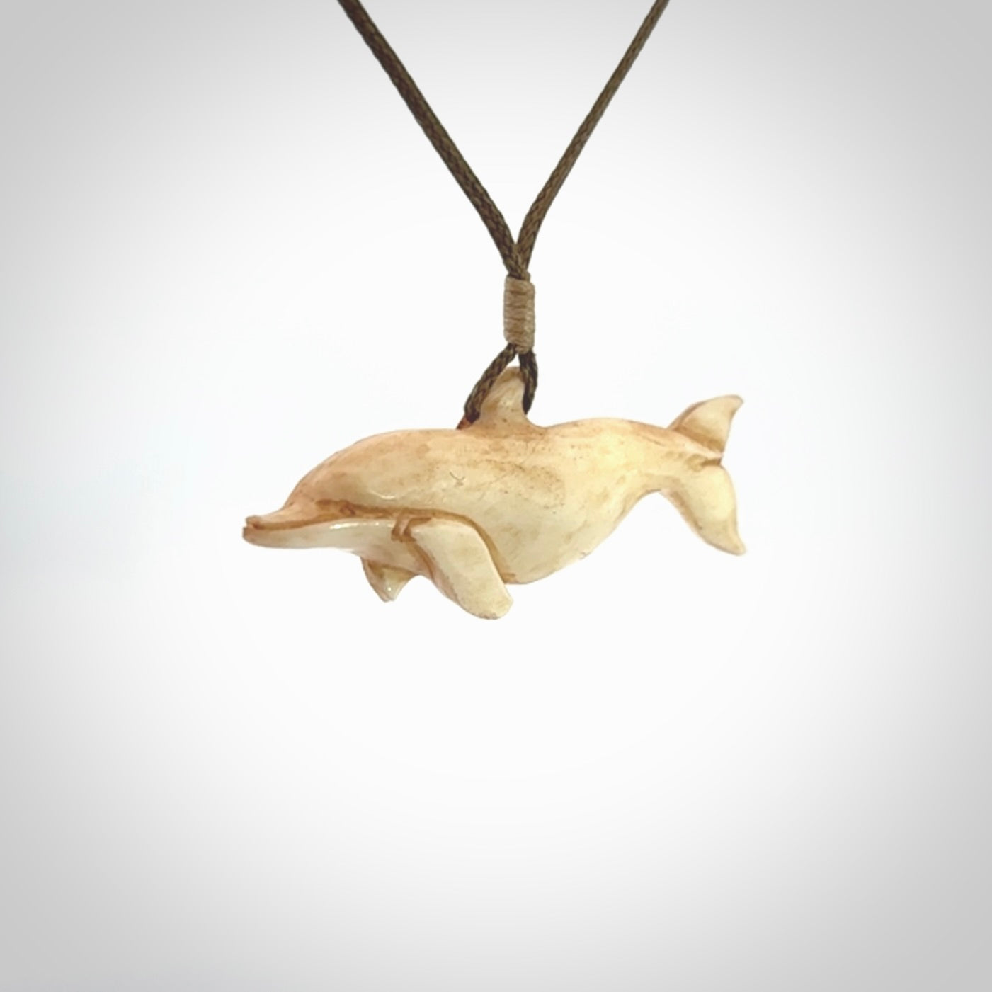 Hand carved dolphin bone pendant. Hand made bone dolphin necklace. Hand crafted bone dolphin pendant. Provided with an adjustable cord.