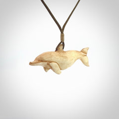 Hand carved dolphin bone pendant. Hand made bone dolphin necklace. Hand crafted bone dolphin pendant. Provided with an adjustable cord.