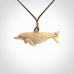 Hand carved dolphin bone pendant. Hand made bone dolphin necklace. Hand crafted bone dolphin pendant. Provided with an adjustable cord.