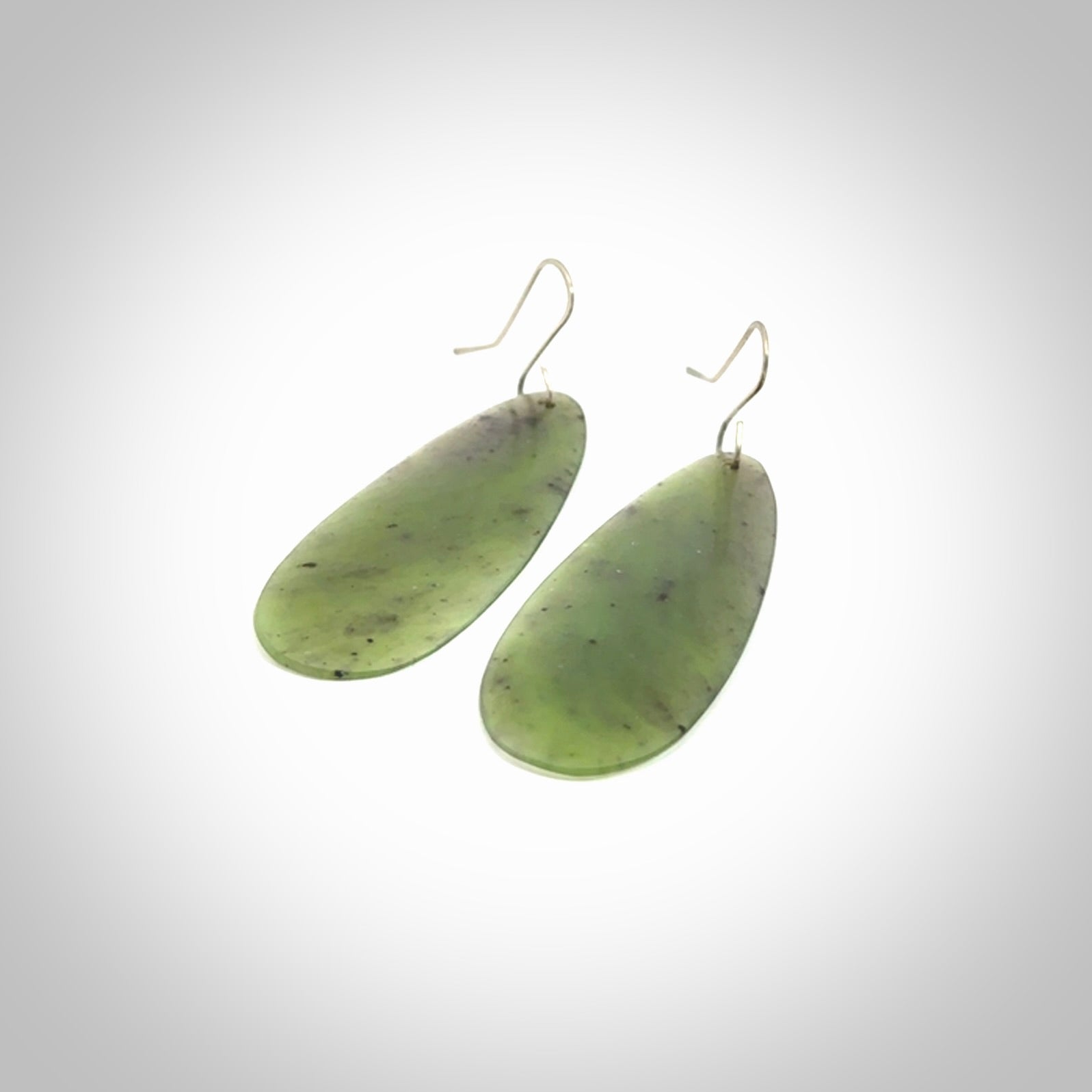 These are stunning large drop shaped jade earrings carved in New Zealand by Darren Hill. It is carved from a semi-translucent light green piece of New Zealand Jade and with Sterling Silver hooks.