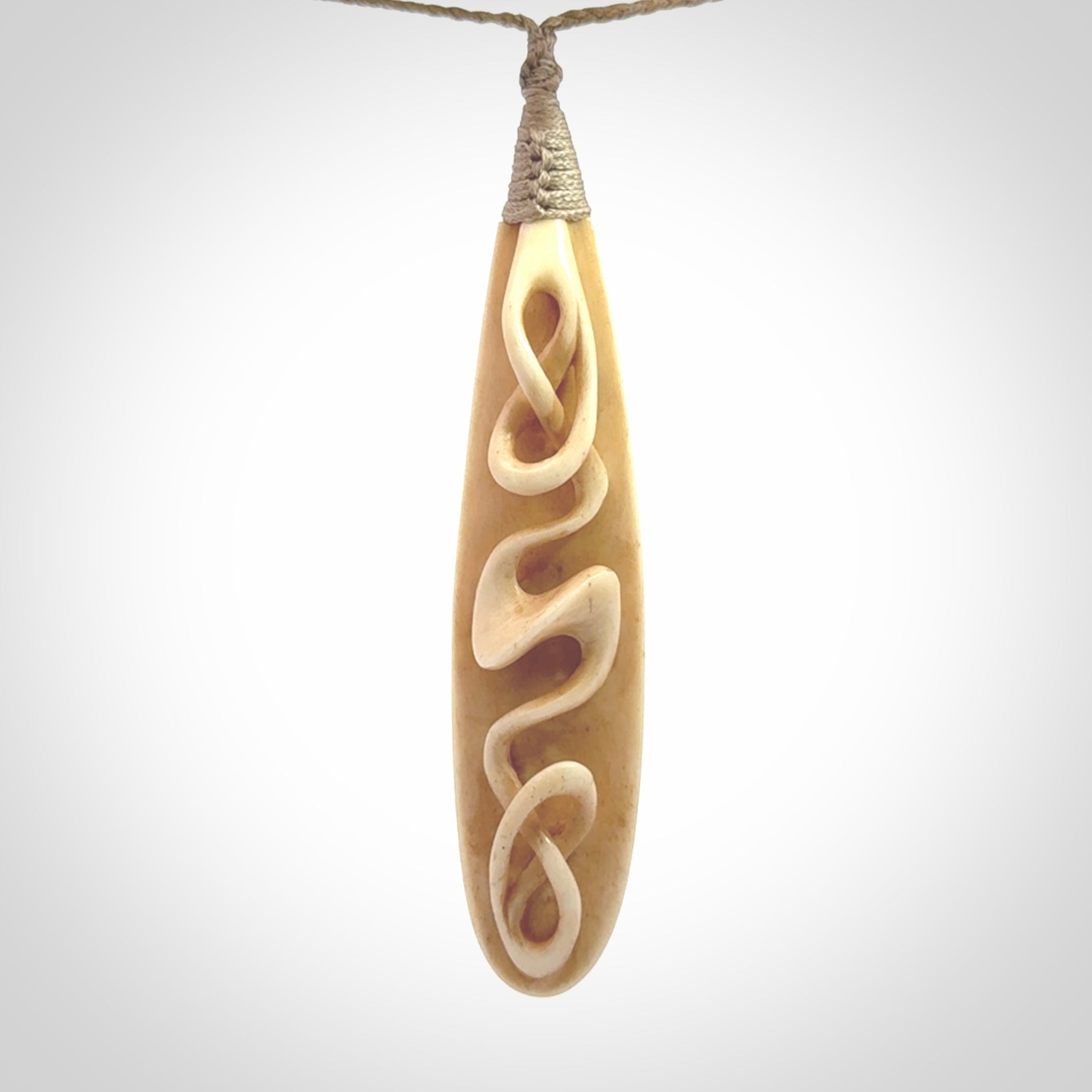 A handcarved masterpiece. A complex twist pendant carved from bone by Yuri Terenyi for NZ Pacific. This is a true piece of wearable art which is collectible. A one-off masterpiece and quite unique. Delivered with Express Courier and gift wrapped in a woven kete pouch.