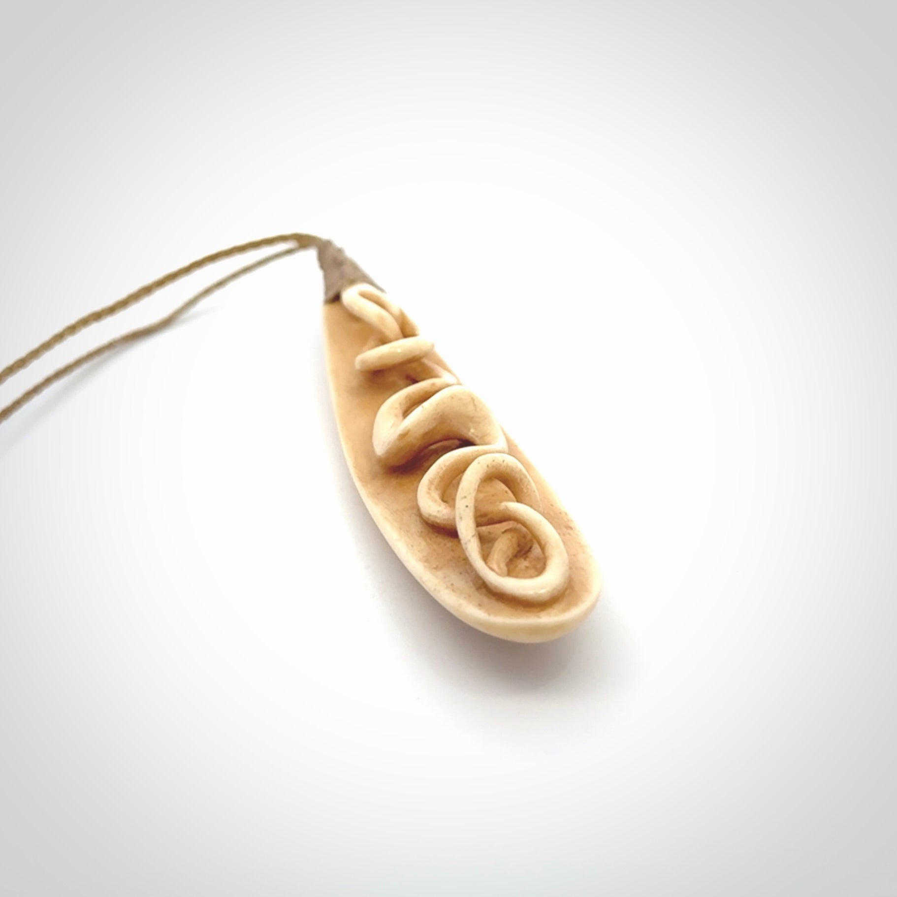 A handcarved masterpiece. A complex twist pendant carved from bone by Yuri Terenyi for NZ Pacific. This is a true piece of wearable art which is collectible. A one-off masterpiece and quite unique. Delivered with Express Courier and gift wrapped in a woven kete pouch.