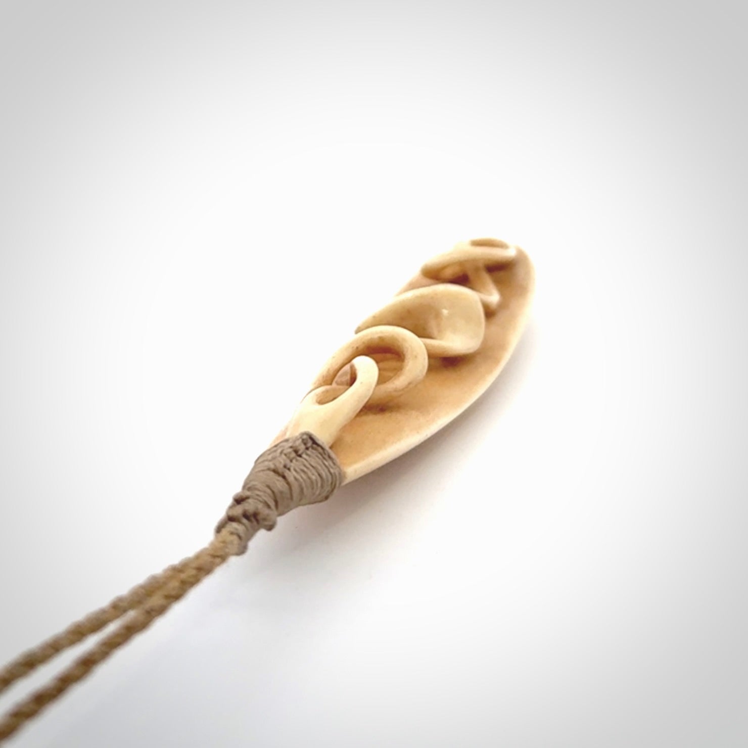 A handcarved masterpiece. A complex twist pendant carved from bone by Yuri Terenyi for NZ Pacific. This is a true piece of wearable art which is collectible. A one-off masterpiece and quite unique. Delivered with Express Courier and gift wrapped in a woven kete pouch.