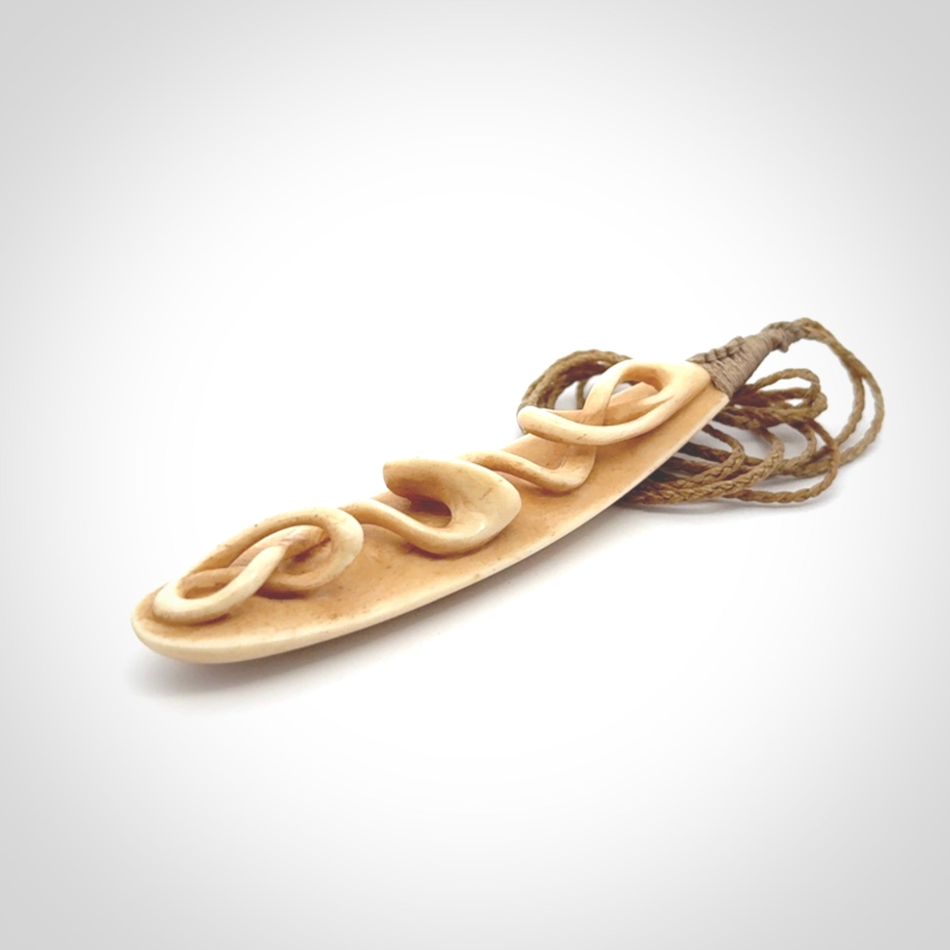 A handcarved masterpiece. A complex twist pendant carved from bone by Yuri Terenyi for NZ Pacific. This is a true piece of wearable art which is collectible. A one-off masterpiece and quite unique. Delivered with Express Courier and gift wrapped in a woven kete pouch.