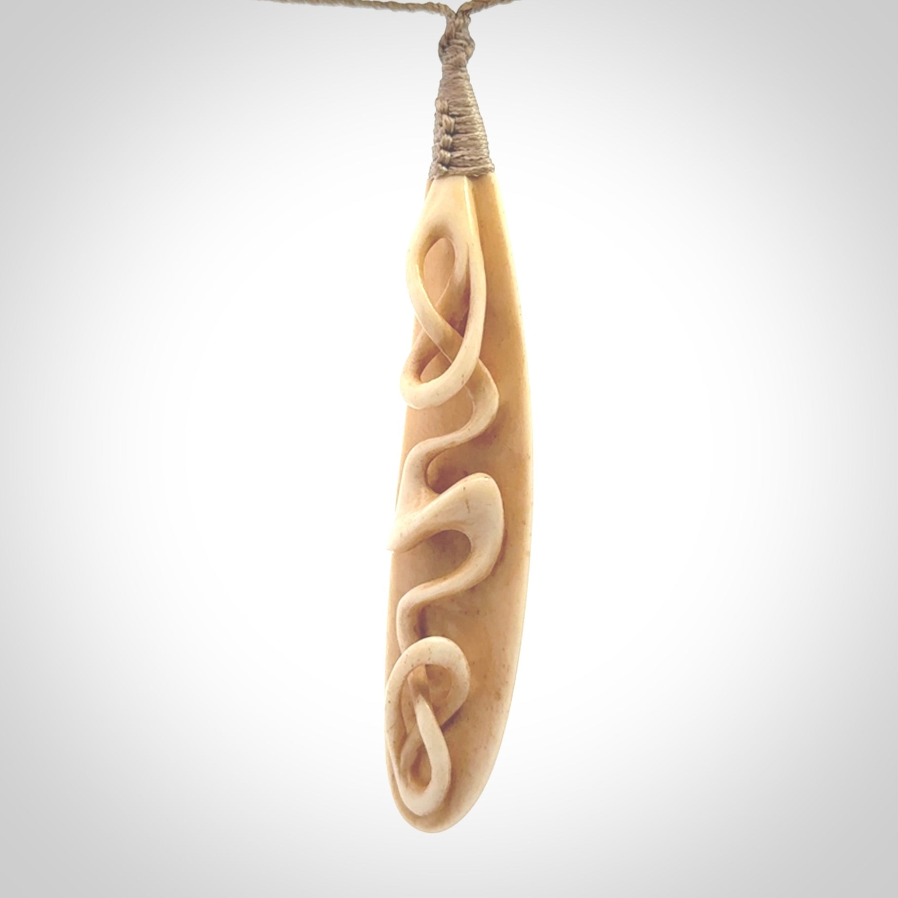 A handcarved masterpiece. A complex twist pendant carved from bone by Yuri Terenyi for NZ Pacific. This is a true piece of wearable art which is collectible. A one-off masterpiece and quite unique. Delivered with Express Courier and gift wrapped in a woven kete pouch.
