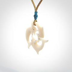 Hand carved dolphin trio pendant, made from natural bone by NZ Pacific. Hand made natural bone dolphin trilogy necklace, provided with an adjustable cord