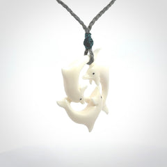 Hand carved dolphin trio pendant, made from natural bone by NZ Pacific. Hand made natural bone dolphin trilogy necklace, provided with an adjustable cord