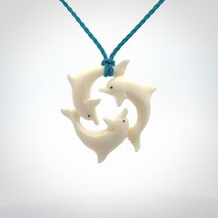 Hand carved dolphin trio pendant, made from natural bone by NZ Pacific. Hand made natural bone dolphin trilogy necklace, provided with an adjustable cord