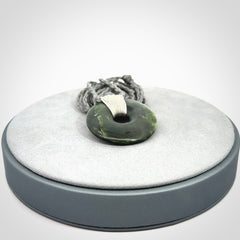 These are medium sized pendants - very finely carved. They are New Zealand Jade discs with a centre hole. It is suspended from a cord which is adjustable. These are beautiful pieces of expressive jade jewellery. Unique New Zealand made pendants for men and women. Perfect gifts for all.