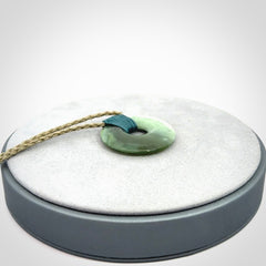 These are medium sized pendants - very finely carved. They are New Zealand Jade discs with a centre hole. It is suspended from a cord which is adjustable. These are beautiful pieces of expressive jade jewellery. Unique New Zealand made pendants for men and women. Perfect gifts for all.