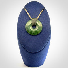 These are medium sized pendants - very finely carved. They are New Zealand Jade discs with a centre hole. It is suspended from a cord which is adjustable. These are beautiful pieces of expressive jade jewellery. Unique New Zealand made pendants for men and women. Perfect gifts for all.